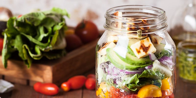 a jar of salads with a salad in a jar