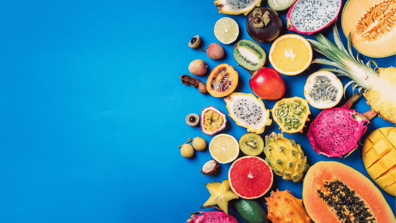 a variety of fruits and vegetables on a blue background